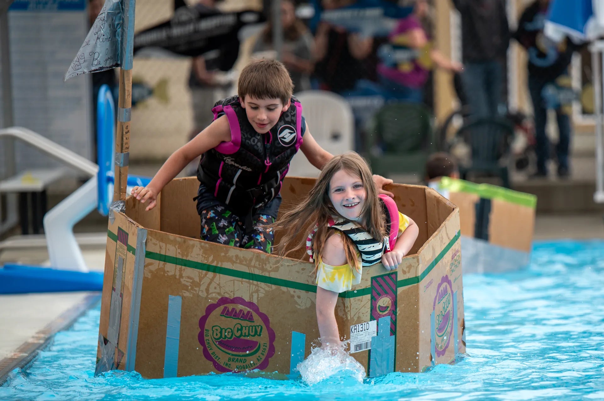 Kids racing cardboard boats