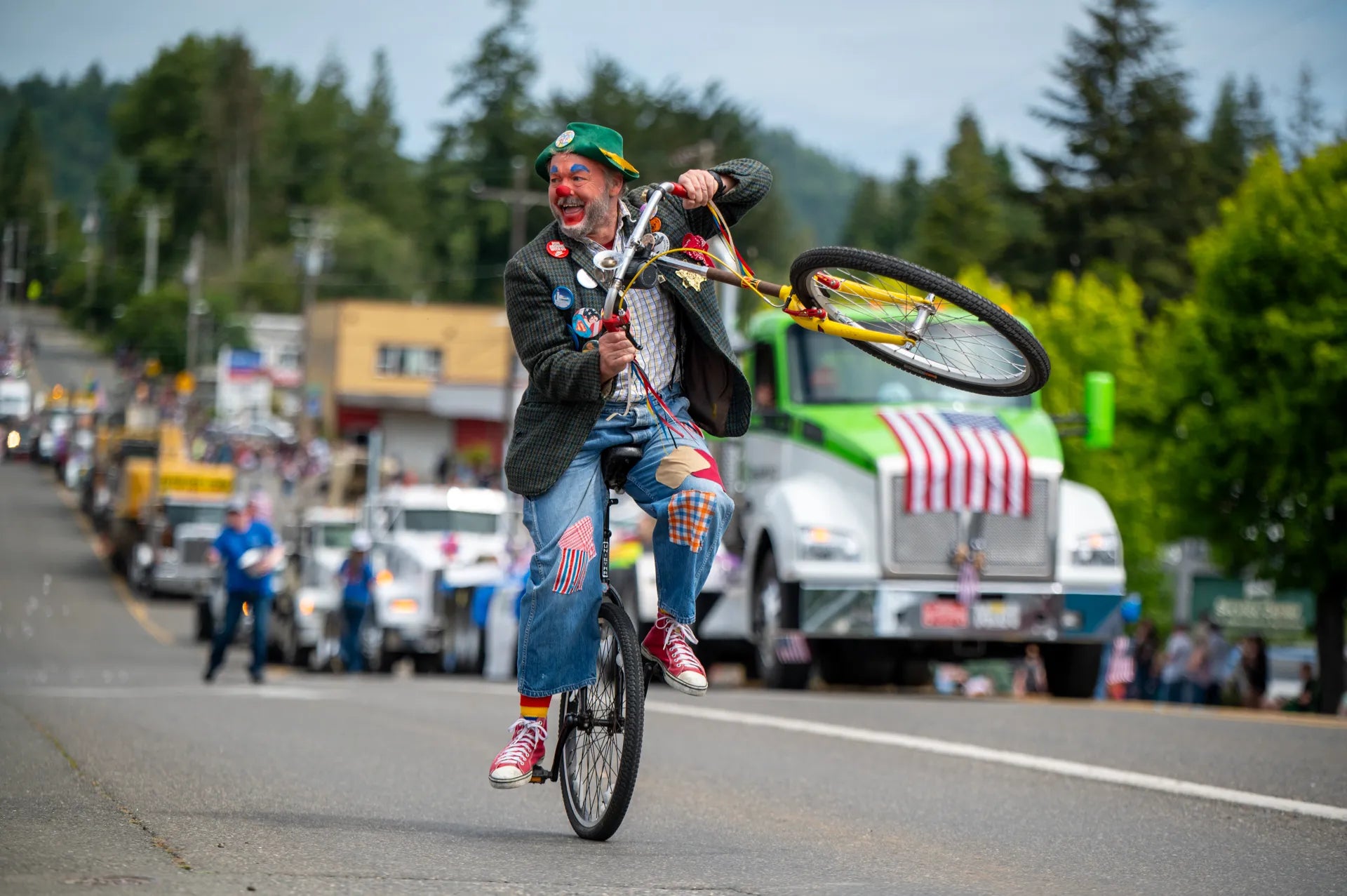 Clown on a tall bike in the parade