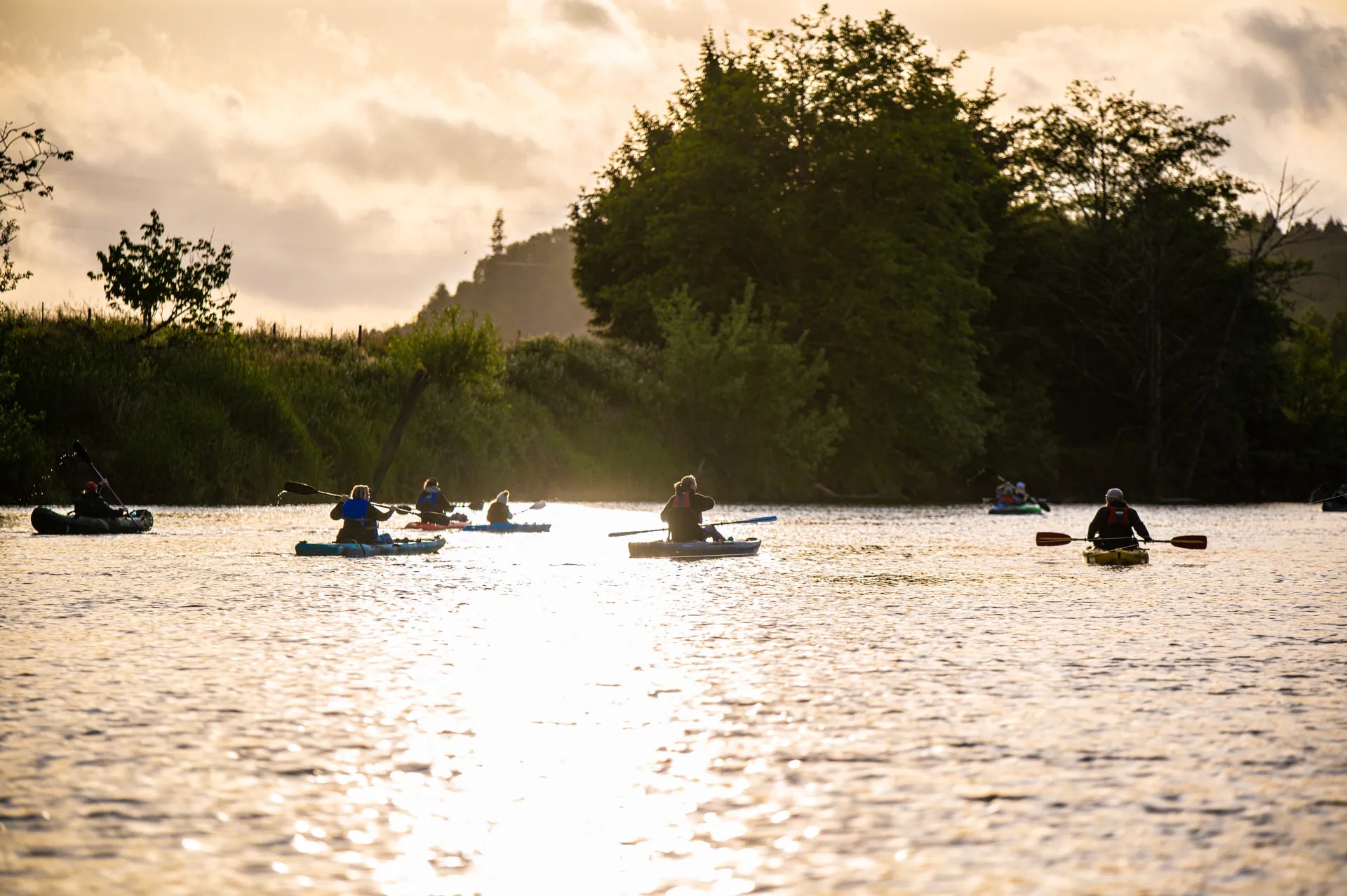 Kayakers on the Coquille River at golden hour